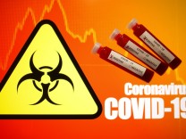 Fake blood is seen in test tubes labelled with the coronavirus (COVID-19) in this illustration